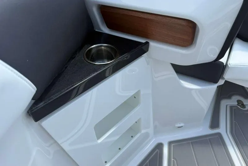 Slide: The Image of Interior detail of 2026 Monterey Elite 30 OB boat with cup holder and storage. - 54