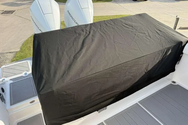 Slide: The Image of 2026 Monterey Elite 30 OB boat with covered seating area and dual Mercury outboard engines. - 88