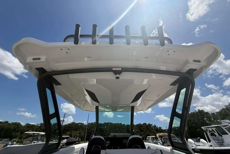 Slide: The Image of 2026 Monterey Elite 30 OB boat with sleek design under sunny sky. - 73