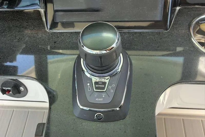 Slide: The Image of Joystick control on 2026 Monterey Elite 30 OB boat dashboard. - 79