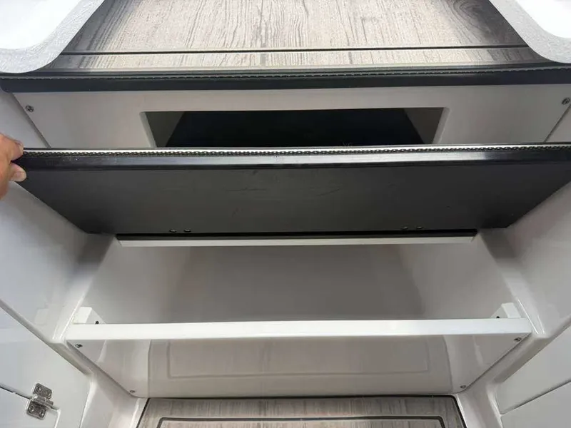 Slide: The Image of Storage compartment in the Monterey Elite 30 OB boat. - 12