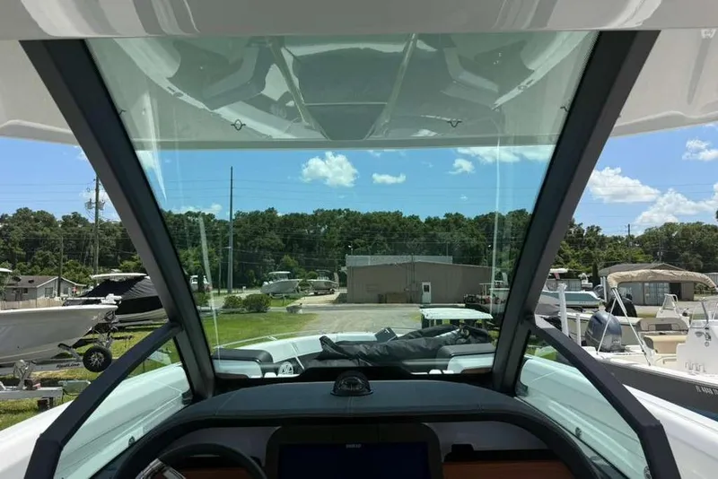 Slide: The Image of Interior view of 2026 Monterey Elite 30 OB boat, showcasing windshield and dashboard. - 75