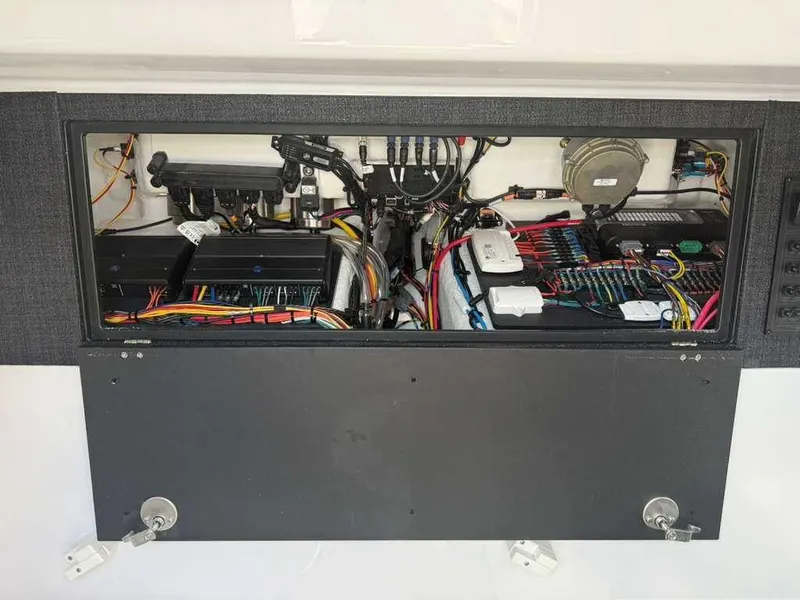 Slide: The Image of Electronic and wiring system inside a boat, neatly organized and accessible. - 15