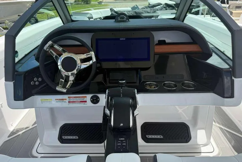Slide: The Image of Cockpit of 2026 Monterey Elite 30 OB boat with modern steering and controls. - 83