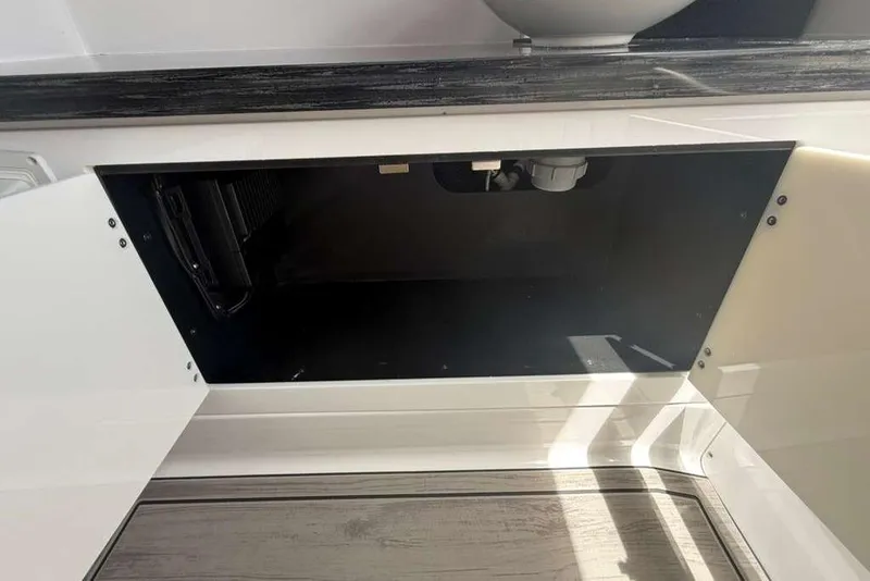 Slide: The Image of Open cabinet space in 2026 Monterey Elite 30 OB boat interior. - 32