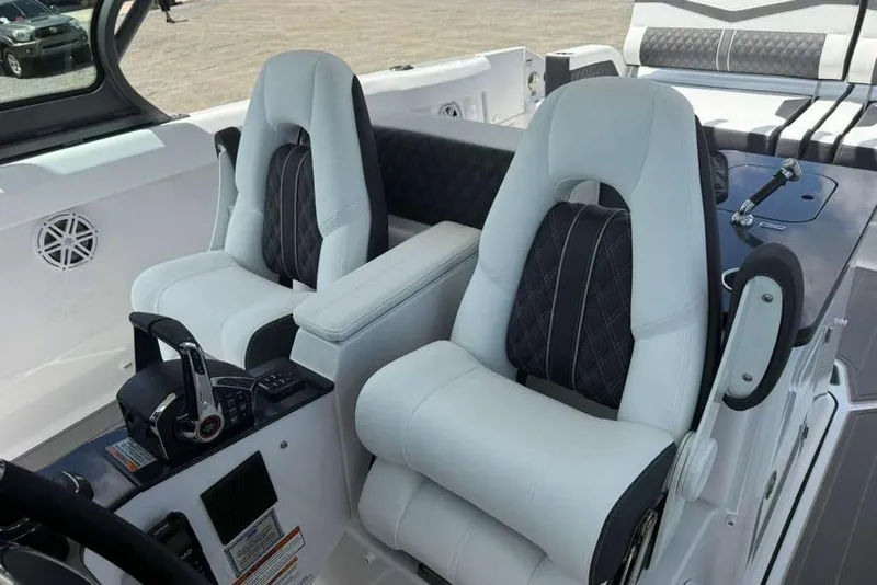 Slide: The Image of Luxury seating and controls on 2026 Monterey Elite 30 OB boat interior. - 68