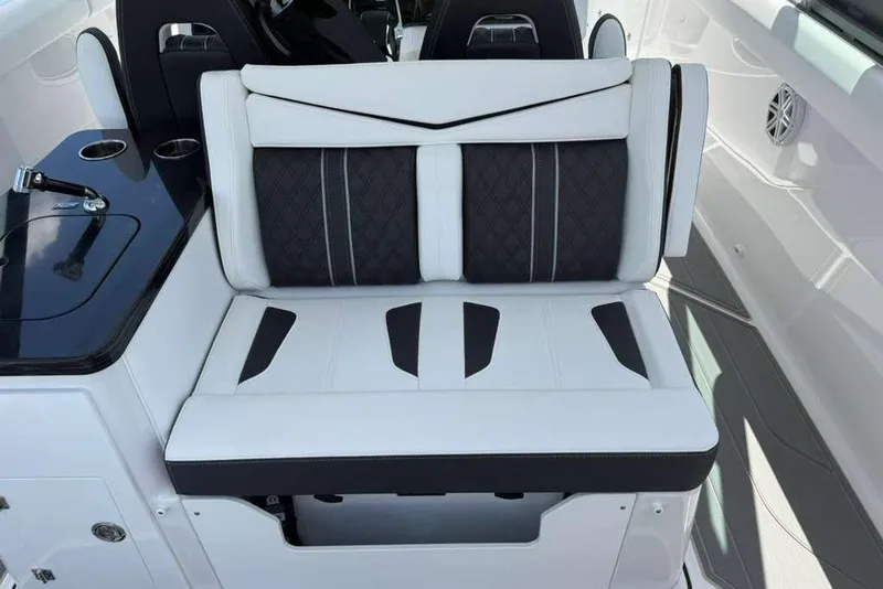 Slide: The Image of Luxury seating on 2026 Monterey Elite 30 OB boat, featuring sleek black and white design. - 64