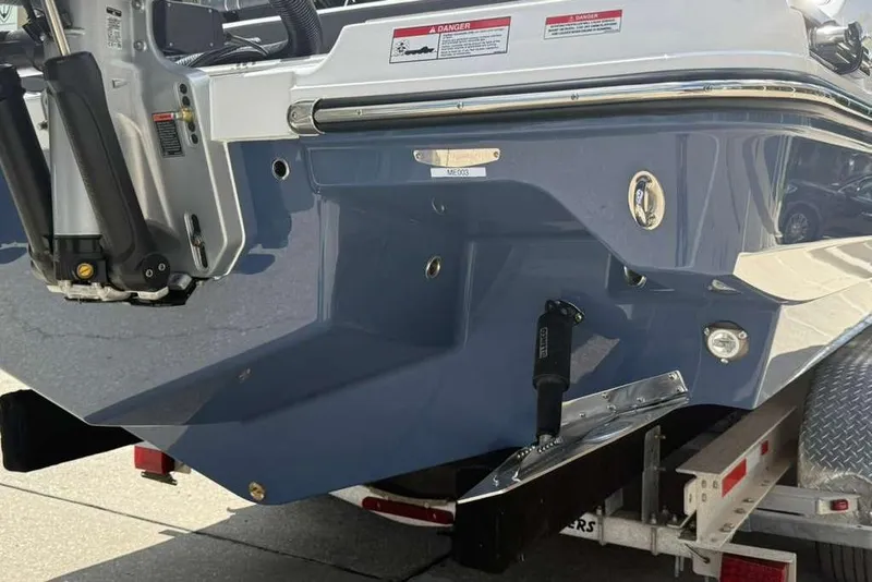 Slide: The Image of Rear view of a 2026 Monterey Elite 30 OB boat on a trailer. - 26