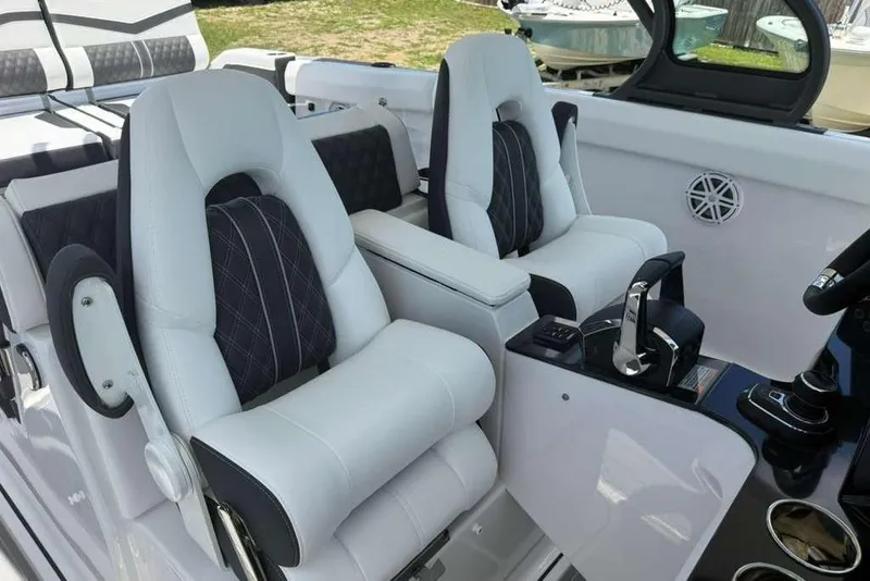 Slide: The Image of Luxurious interior of 2026 Monterey Elite 30 OB boat with plush seating and modern controls. - 72