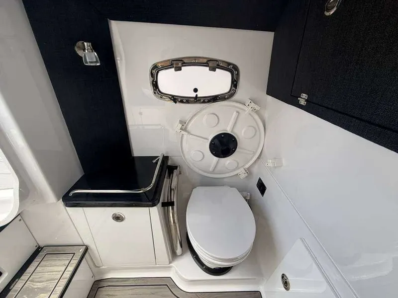 Slide: The Image of Interior view of a boat cabin with a toilet and sink. - 17