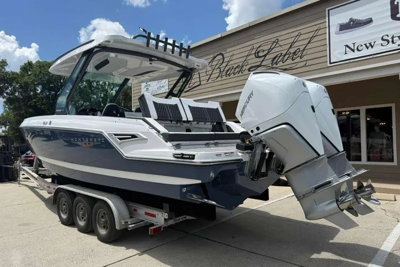 Slide: The Image of 2026 Monterey Elite 30 OB boat on trailer, featuring dual Mercury outboard engines. - 84