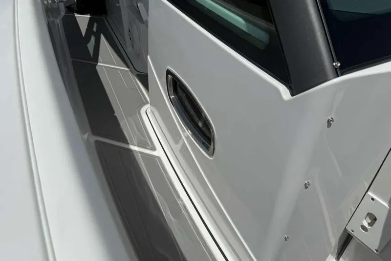 Slide: The Image of 2026 Monterey Elite 30 OB boat deck with sleek white and gray design. - 52