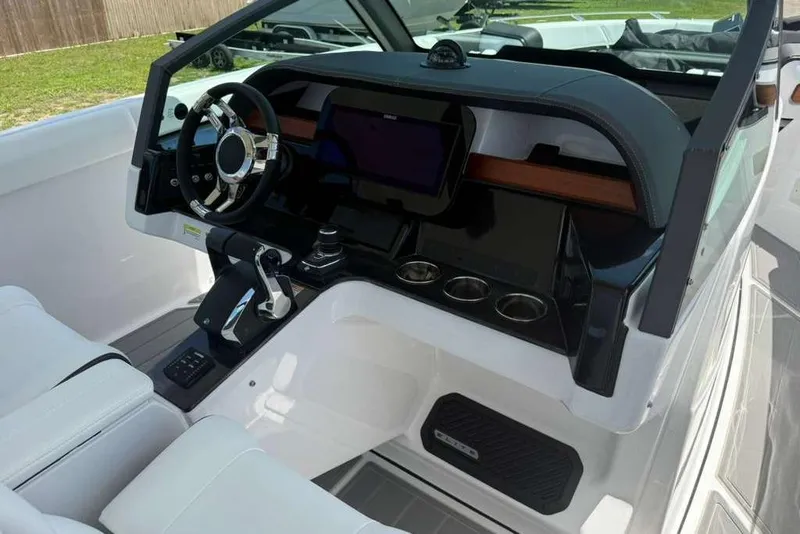 Slide: The Image of 2026 Monterey Elite 30 OB boat cockpit with modern steering and control panel. - 74