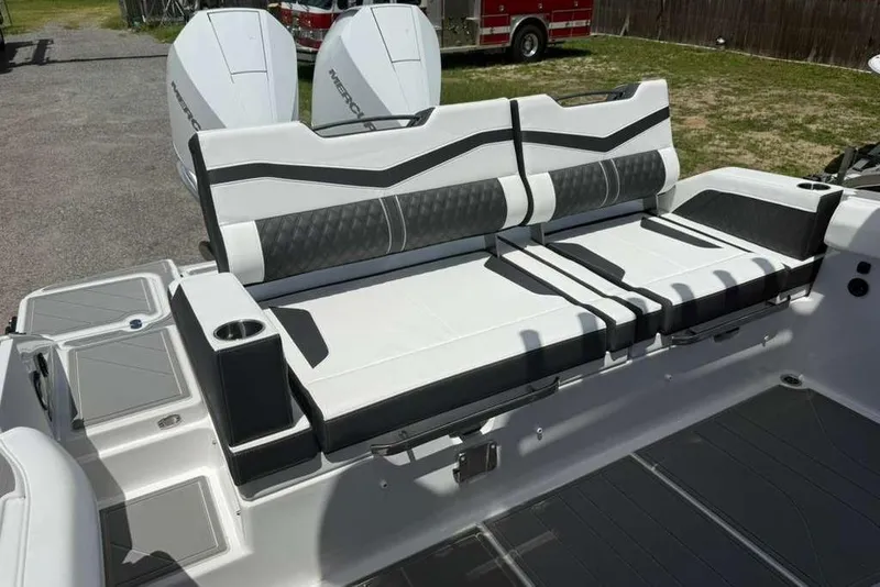 Slide: The Image of Luxury seating on 2026 Monterey Elite 30 OB boat, featuring sleek design and dual outboard engines. - 67