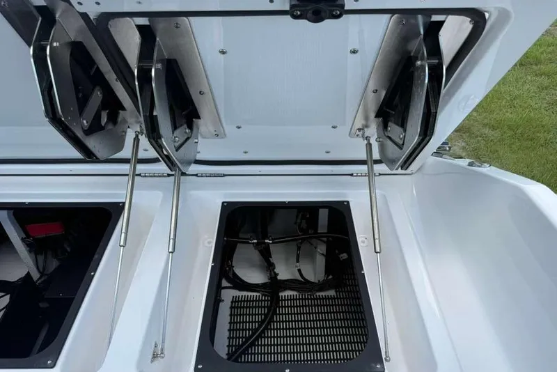 Slide: The Image of Open storage compartments on a 2026 Monterey Elite 30 OB boat, showcasing interior details. - 59