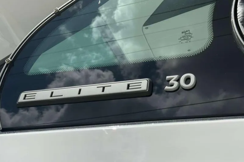 Slide: The Image of 2026 Monterey Elite 30 OB boat emblem with reflective glass background. - 85