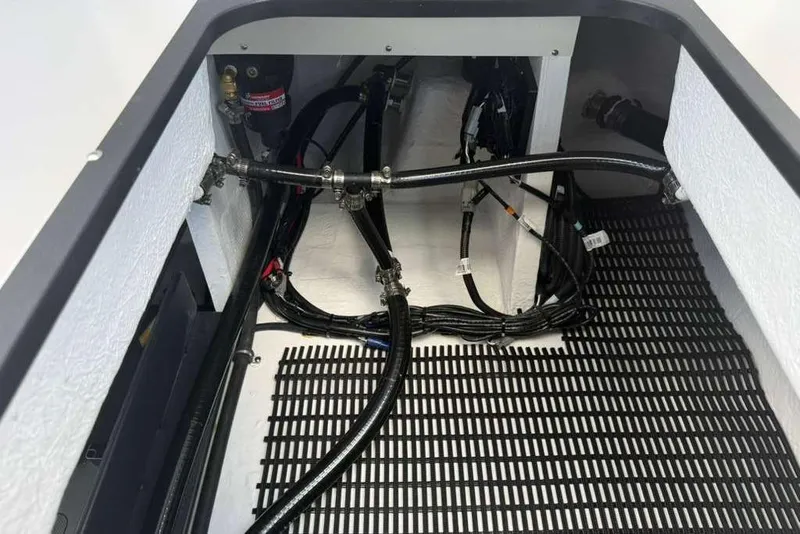 Slide: The Image of Engine compartment of 2026 Monterey Elite 30 OB boat with visible wiring and hoses. - 58