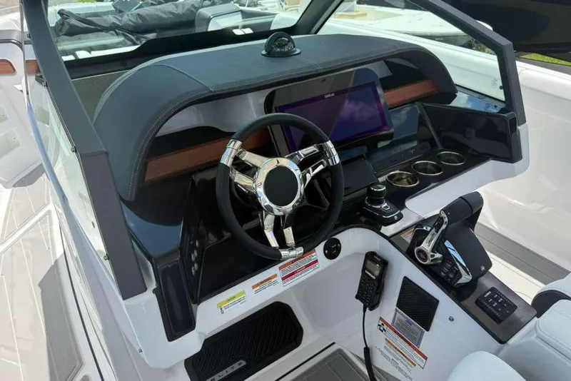 Slide: The Image of 2026 Monterey Elite 30 OB boat dashboard with modern steering wheel and control panel. - 70