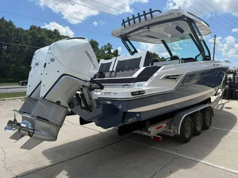 Slide: The Image of A Monterey Elite 30 OB boat on a trailer, featuring a powerful outboard motor. - 7