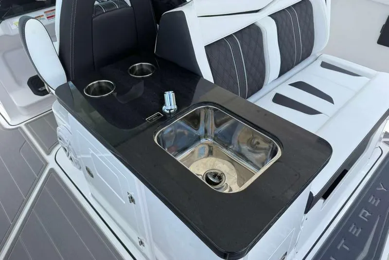 Slide: The Image of Luxury seating and sink area on 2026 Monterey Elite 30 OB boat. - 65