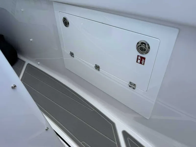 Slide: The Image of Interior view of a boat with gray flooring and white storage compartment. - 22