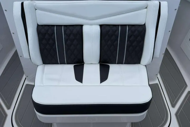 Slide: The Image of Luxury seating on 2026 Monterey Elite 30 OB boat, featuring elegant black and white upholstery. - 38