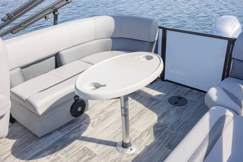 Slide: The Image of 2026 Bentley Pontoons LE 200 CR interior with seating and table on water. - 3