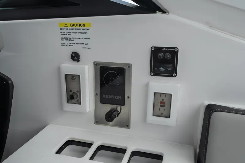 Slide: The Image of Control panel on 2026 Monterey 385SS Super Sport boat with caution label and outlets. - 12