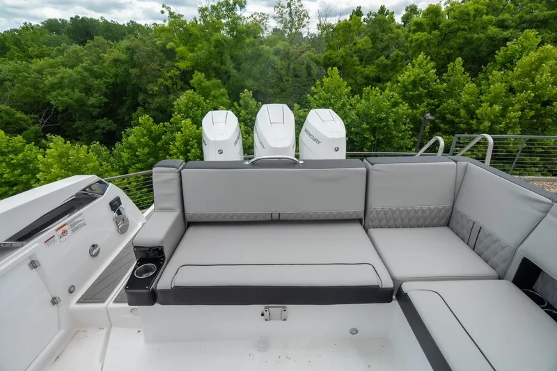Slide: The Image of 2026 Monterey 385SS Super Sport boat with luxurious seating and triple outboard engines. - 15