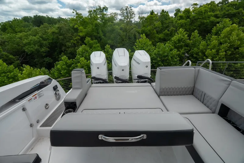 Slide: The Image of 2026 Monterey 385SS Super Sport boat with luxurious seating and triple outboard engines. - 17