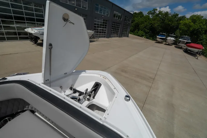 Slide: The Image of 2026 Monterey 385SS Super Sport boat with open hatch, parked near a showroom. - 22