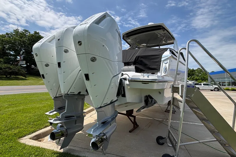 Slide: The Image of 2026 Monterey 385SS Super Sport boat with triple outboard engines on display. - 3