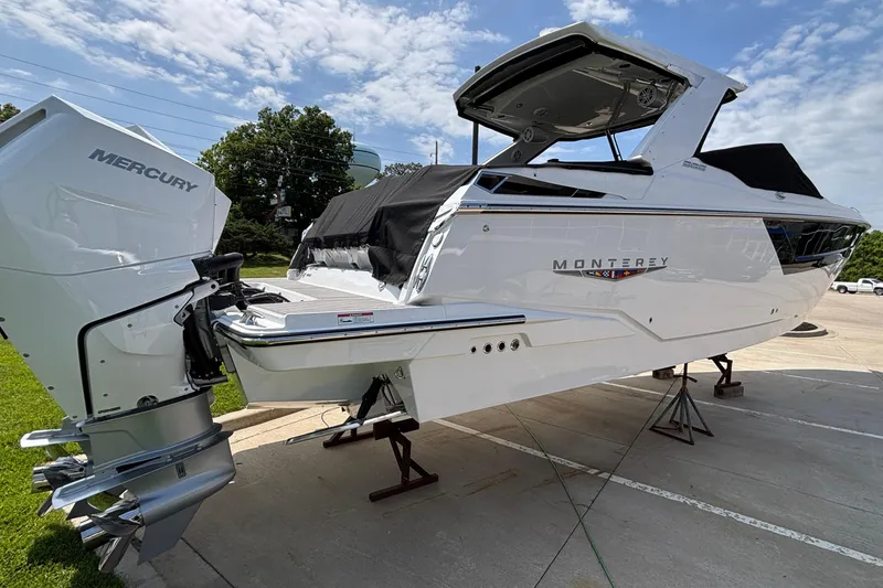 Slide: The Image of 2026 Monterey 385SS Super Sport boat with Mercury engine on display outdoors. - 4