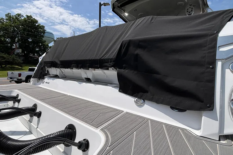 Slide: The Image of 2026 Monterey 385SS Super Sport boat with black cover on deck, outdoor setting. - 7