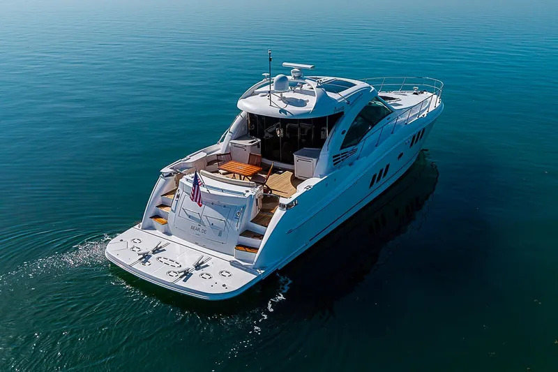Slide: The Image of 2008 Sea Ray 60 Sundancer yacht cruising on calm blue waters. - 3