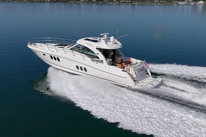 Slide: The Image of 2008 Sea Ray 60 Sundancer yacht cruising on calm blue waters. - 10