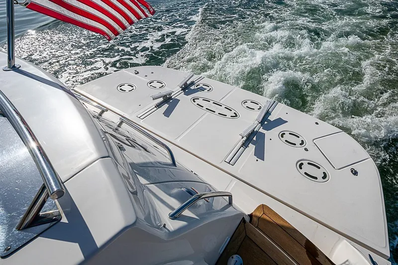 Slide: The Image of 2008 Sea Ray 60 Sundancer yacht with American flag, cruising on water. - 66