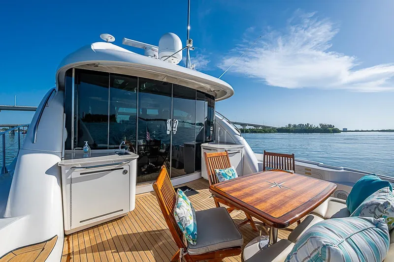 Slide: The Image of Luxurious 2008 Sea Ray 60 Sundancer yacht with elegant outdoor seating and scenic water view. - 60
