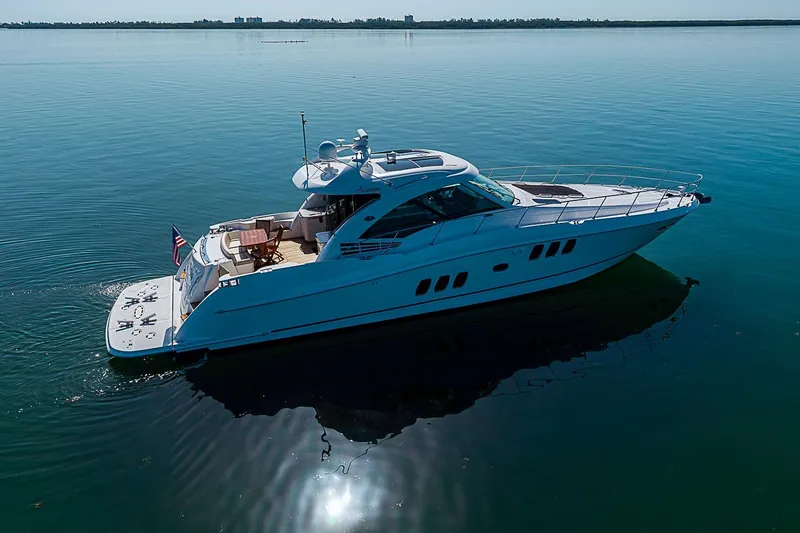 Slide: The Image of 2008 Sea Ray 60 Sundancer yacht cruising on calm waters under clear skies. - 2