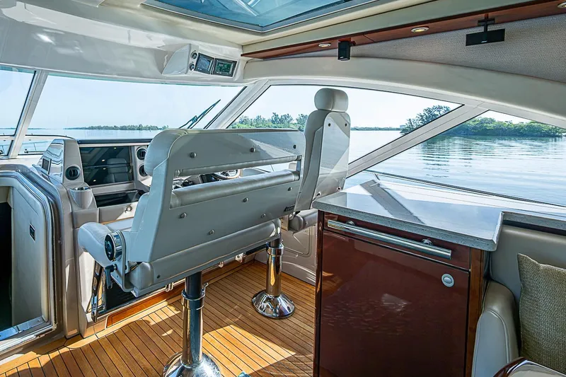 Slide: The Image of Interior of a 2008 Sea Ray 60 Sundancer yacht with helm and seating area. - 20