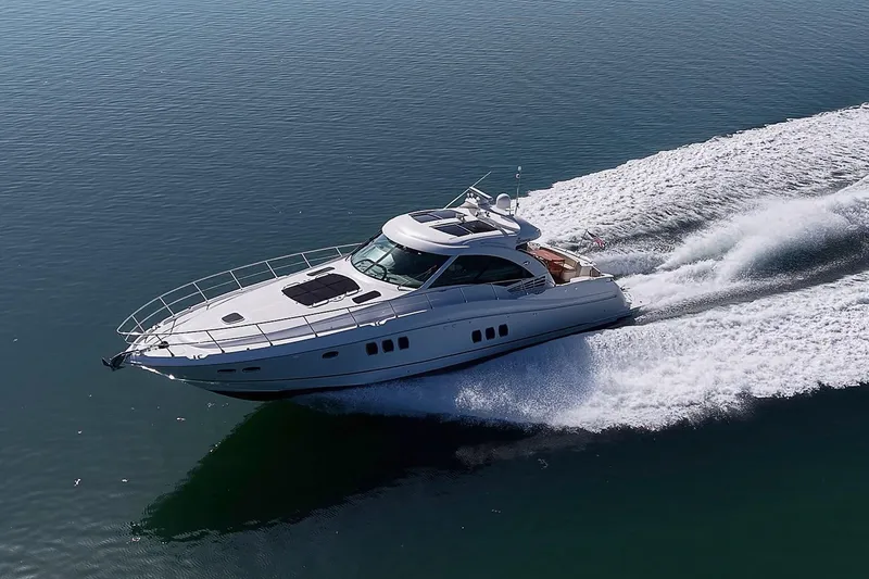 Slide: The Image of 2008 Sea Ray 60 Sundancer yacht cruising on open water, creating a dynamic wake. - 13
