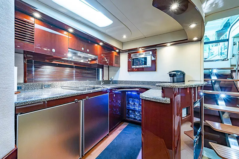 Slide: The Image of Luxurious 2008 Sea Ray 60 Sundancer yacht kitchen with modern amenities and elegant wood finishes. - 32