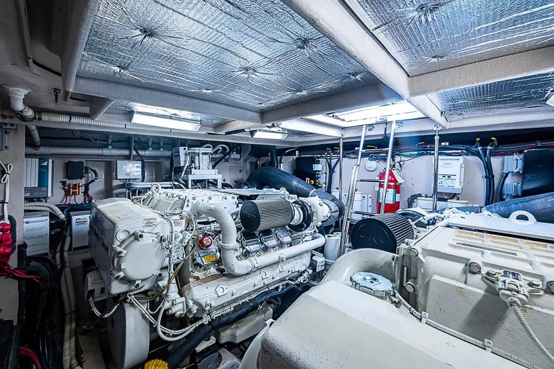 Slide: The Image of Engine room of a 2008 Sea Ray 60 Sundancer yacht, showcasing powerful machinery and equipment. - 69