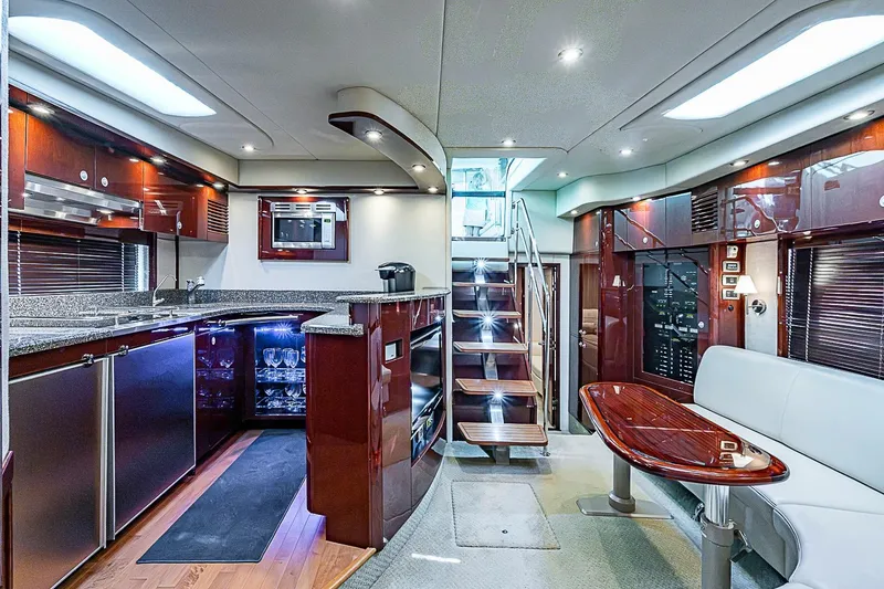 Slide: The Image of Luxurious interior of a 2008 Sea Ray 60 Sundancer yacht with modern kitchen and seating area. - 30