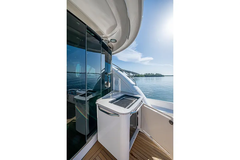 Slide: The Image of 2008 Sea Ray 60 Sundancer yacht deck with sleek design and ocean view. - 64