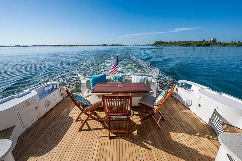 Slide: The Image of 2008 Sea Ray 60 Sundancer yacht deck with chairs, table, and ocean view. - 59