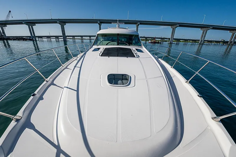 Slide: The Image of 2008 Sea Ray 60 Sundancer yacht cruising under a bridge on a sunny day. - 55