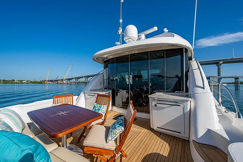 Slide: The Image of Luxurious 2008 Sea Ray 60 Sundancer yacht with elegant deck and scenic waterfront view. - 63