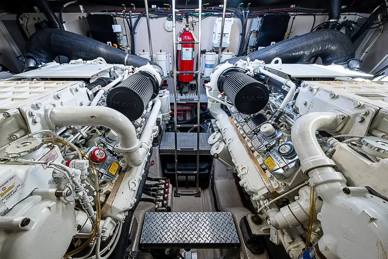 Slide: The Image of Engine room of a 2008 Sea Ray 60 Sundancer yacht, featuring dual MAN engines. - 68