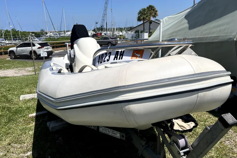 Slide: The Image of Inflatable boat on trailer near marina, with Sea Ray 60 Sundancer, 2008 model. - 76